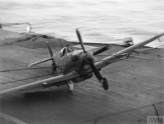 Supermarine Seafire hitting the barrier on HMS INDEFATIGABLE after returning from the strike on a Japanese oil refinery at Pangkalan Brandan, Sumatra